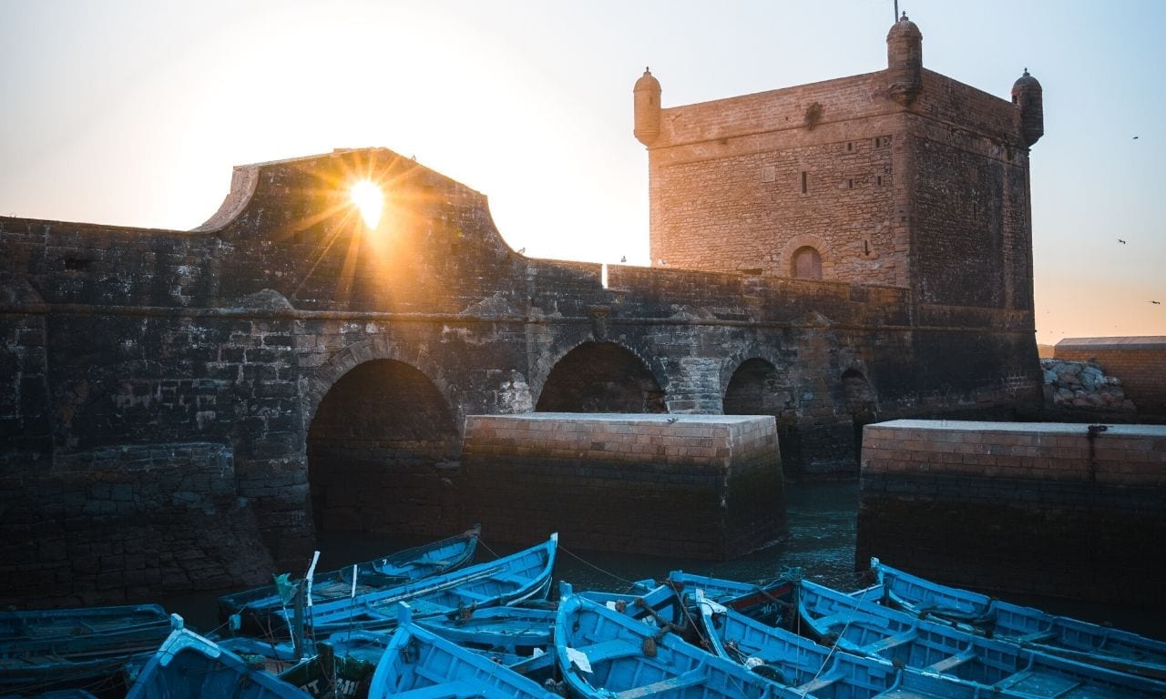Vibrantly blue boats docked along the harbour walls of Essaouira. Captured by Jonny Melon.