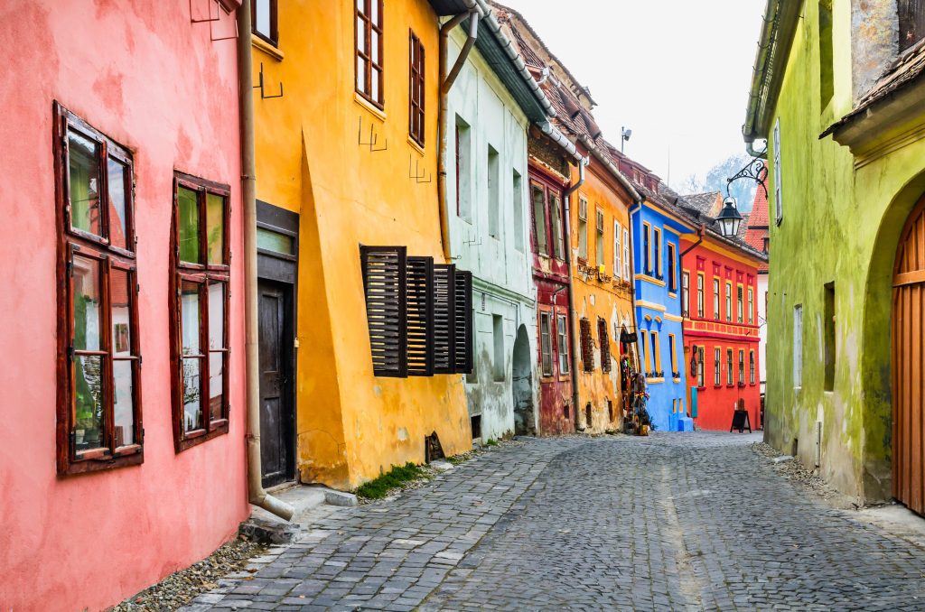 Stone paved old streets with colourful houses in Sighisoara, Transylvania