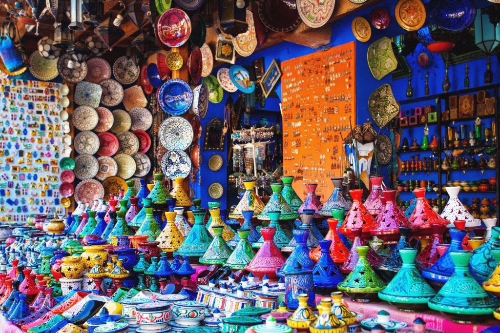 Colored Tajine, plates and pots out of clay on the market of Chefchaouen in Morocco. Moroccan Medina